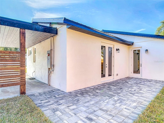 view of side of property featuring a patio area and french doors