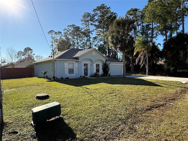 ranch-style home with a garage and a front yard