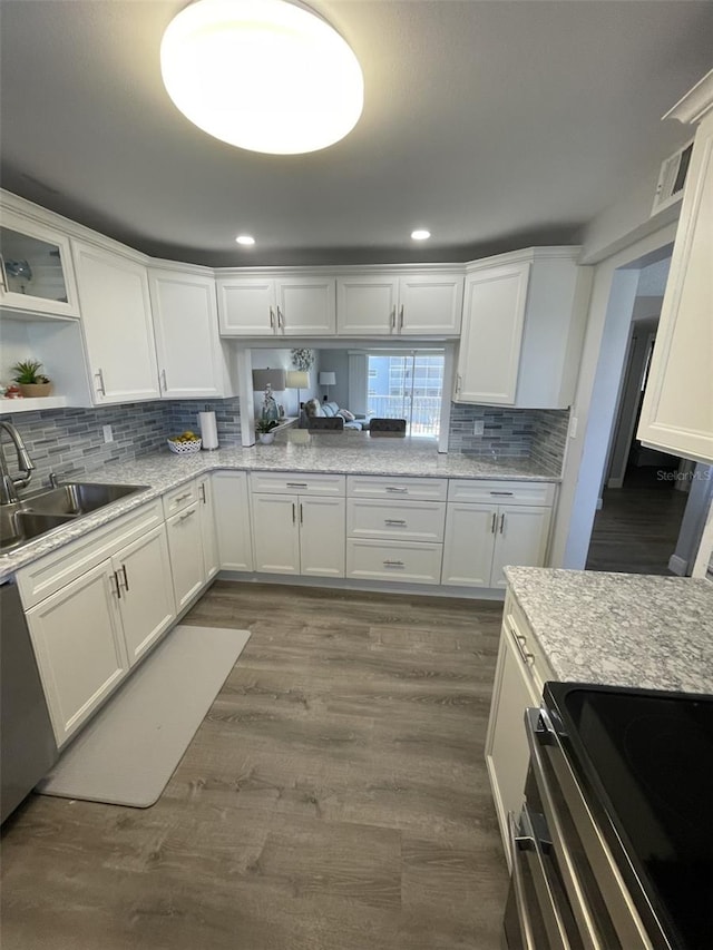 kitchen featuring electric range, dark hardwood / wood-style flooring, sink, and white cabinets