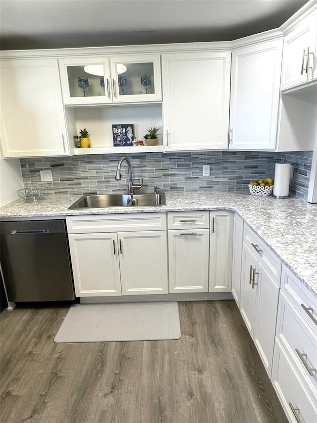 kitchen with dark hardwood / wood-style floors, dishwasher, sink, white cabinets, and light stone counters