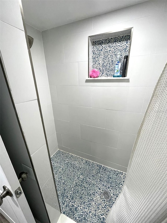 bathroom with tiled shower