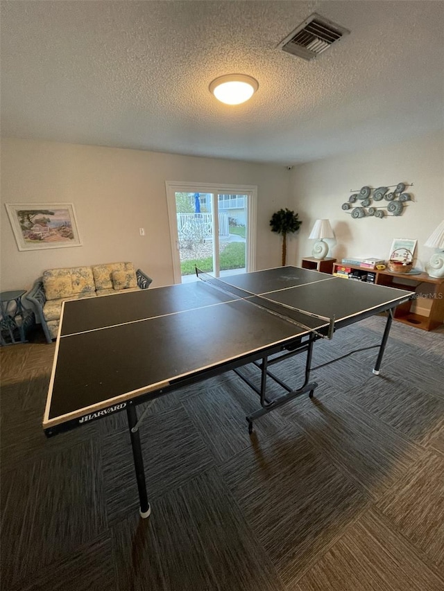 rec room with a textured ceiling and carpet