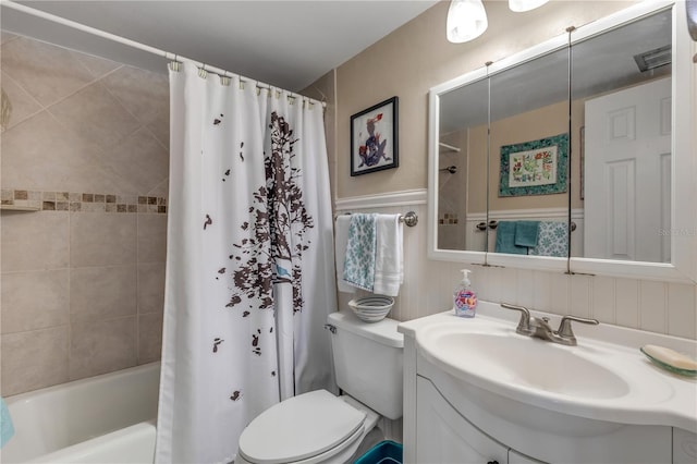 full bathroom with shower / bath combination with curtain, vanity, and toilet