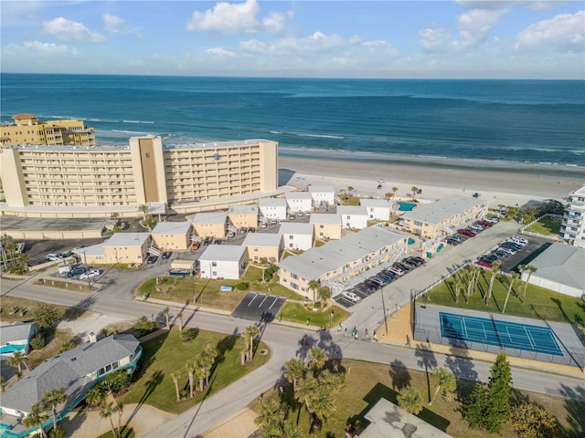 drone / aerial view with a water view and a beach view