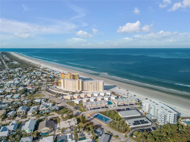 drone / aerial view with a beach view and a water view