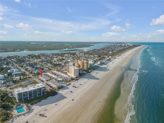 drone / aerial view featuring a view of the beach and a water view