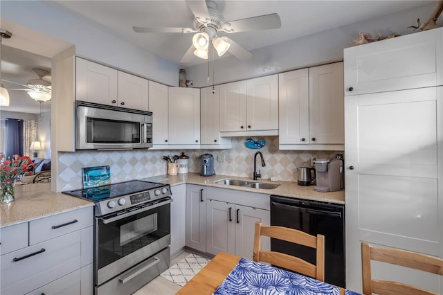 kitchen with sink, tasteful backsplash, ceiling fan, stainless steel appliances, and white cabinets