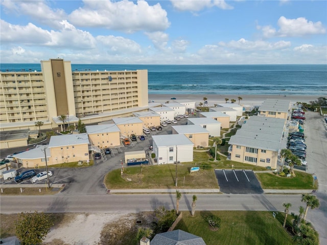 aerial view with a water view and a beach view