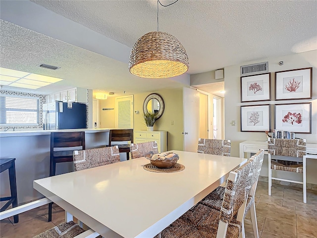 dining area featuring a textured ceiling