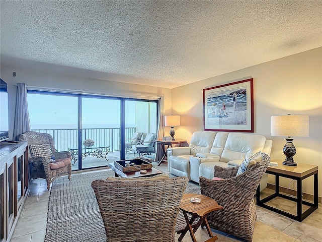 living room featuring a water view and a textured ceiling