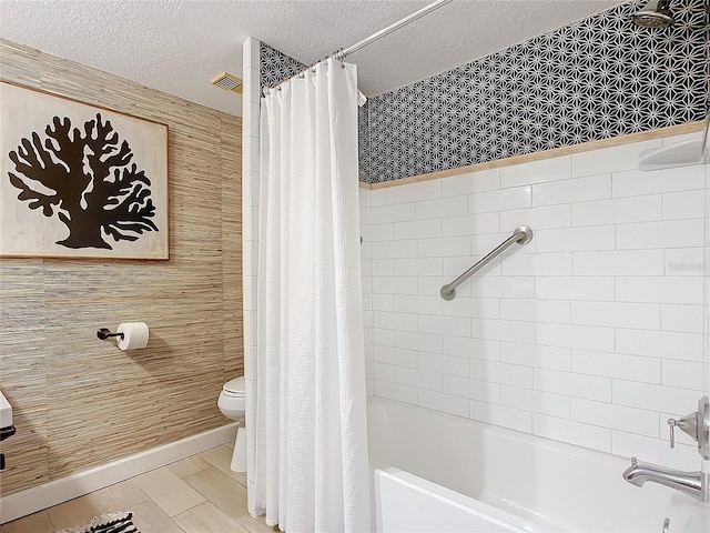 bathroom featuring wood-type flooring, toilet, shower / bath combo with shower curtain, and a textured ceiling