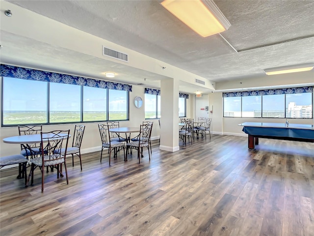 game room with hardwood / wood-style flooring, pool table, and a textured ceiling