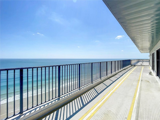 balcony featuring a water view and a view of the beach