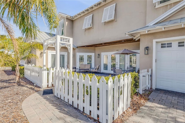 exterior space with a garage and french doors