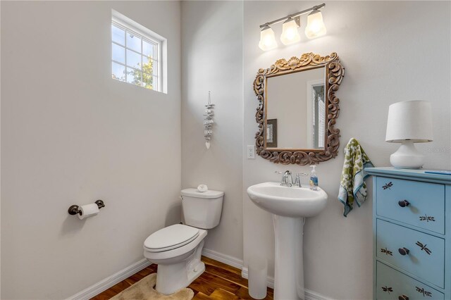 bathroom featuring sink, toilet, and hardwood / wood-style floors