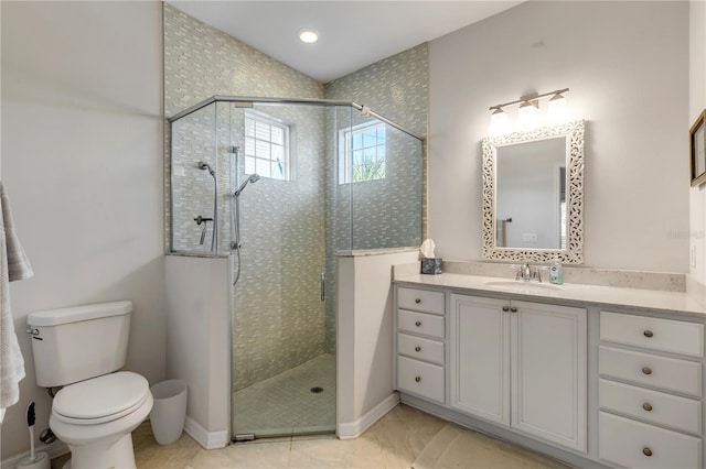 bathroom featuring vanity, tile patterned floors, a shower with door, and toilet