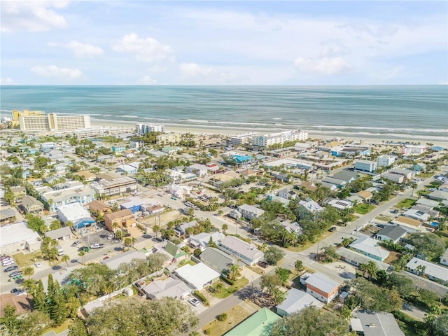 drone / aerial view featuring a water view and a view of the beach