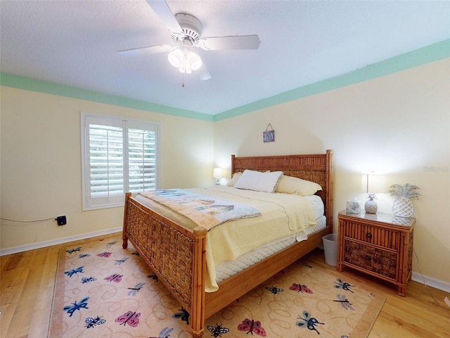 bedroom featuring ceiling fan and light hardwood / wood-style flooring