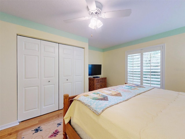 bedroom with wood-type flooring, a closet, and ceiling fan