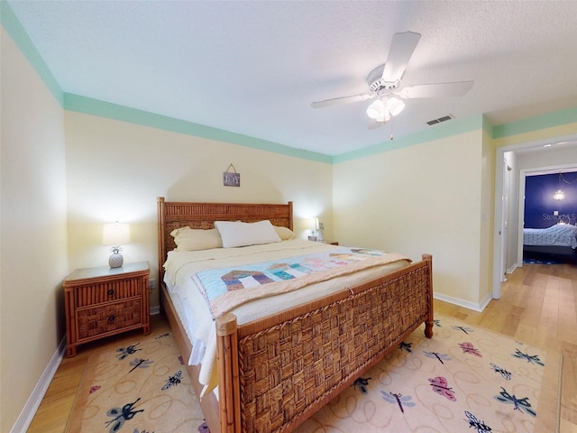 bedroom featuring ceiling fan and light hardwood / wood-style flooring