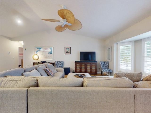 living room with ceiling fan and lofted ceiling