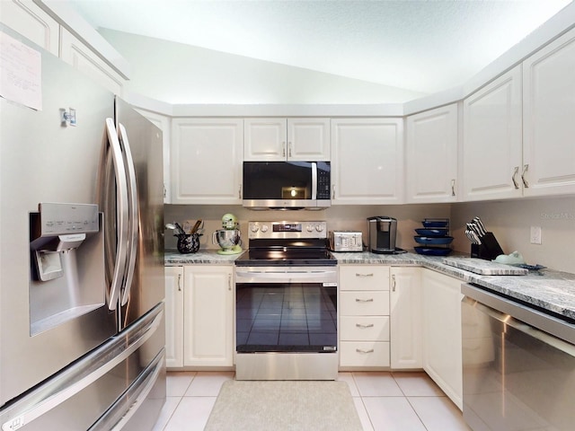 kitchen with white cabinetry, stainless steel appliances, light stone countertops, and light tile patterned floors