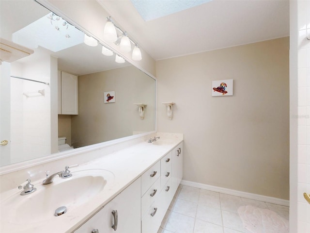 bathroom with tile patterned flooring, vanity, and toilet