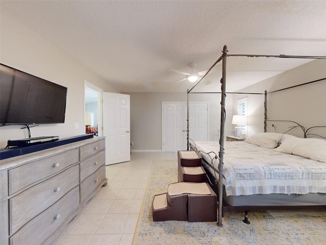 tiled bedroom featuring ceiling fan and a textured ceiling