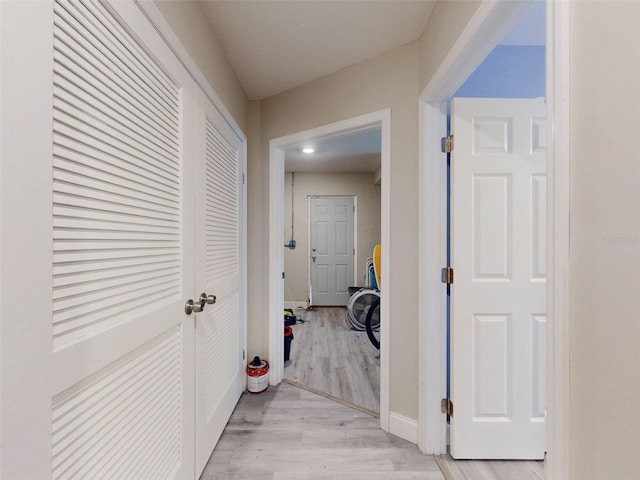 corridor with light hardwood / wood-style flooring