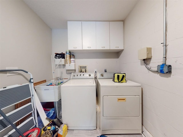 laundry area with cabinets and washer and clothes dryer