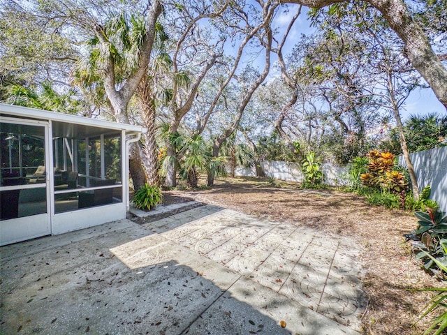 view of patio featuring a sunroom