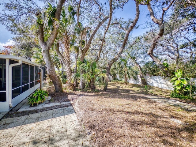 view of yard featuring a patio area and a sunroom