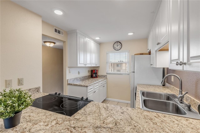 kitchen with white cabinetry, sink, white fridge, range, and light tile patterned floors