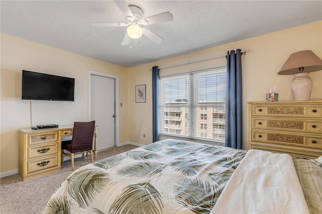 carpeted bedroom with a textured ceiling and ceiling fan