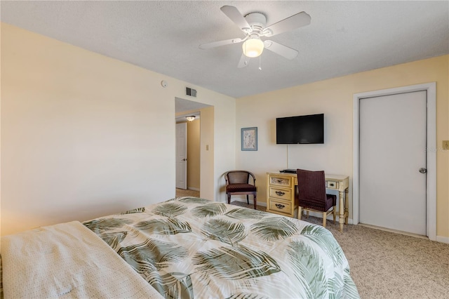 bedroom with carpet floors, a textured ceiling, and ceiling fan