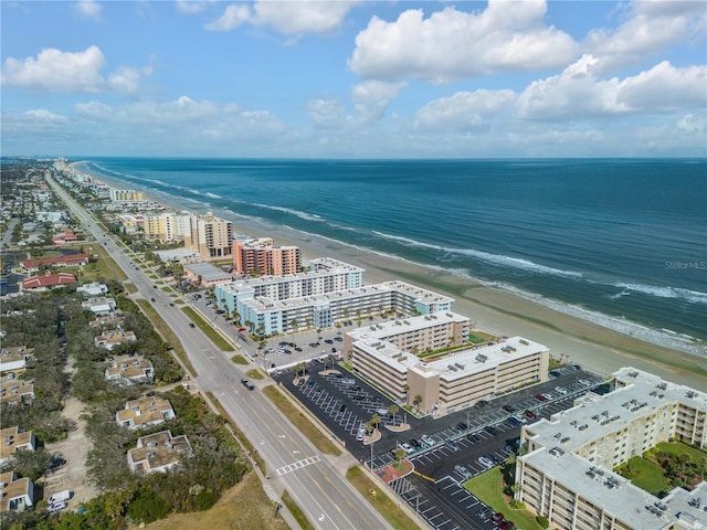 birds eye view of property featuring a water view and a view of the beach