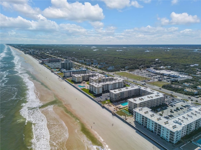 aerial view with a water view and a view of the beach