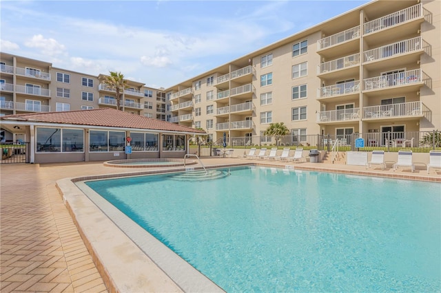 view of pool featuring a hot tub and a patio