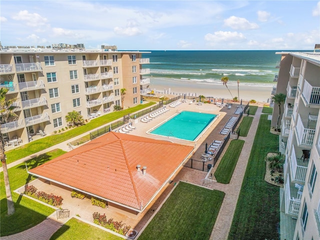 view of pool featuring a water view and a view of the beach