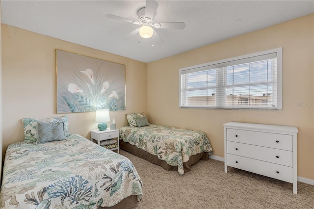 bedroom with ceiling fan and light carpet