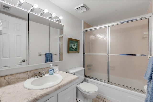 full bathroom with vanity, tile patterned flooring, shower / bath combination with glass door, and toilet