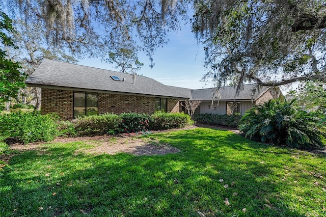 ranch-style home featuring a front yard