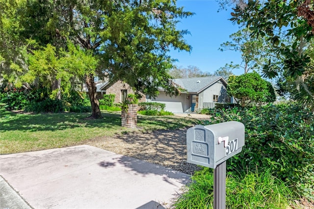 exterior space featuring a garage and a front lawn