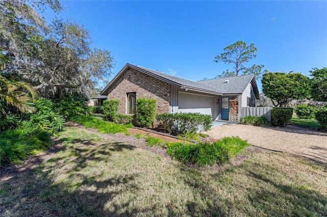 view of front of property featuring a garage and a front lawn