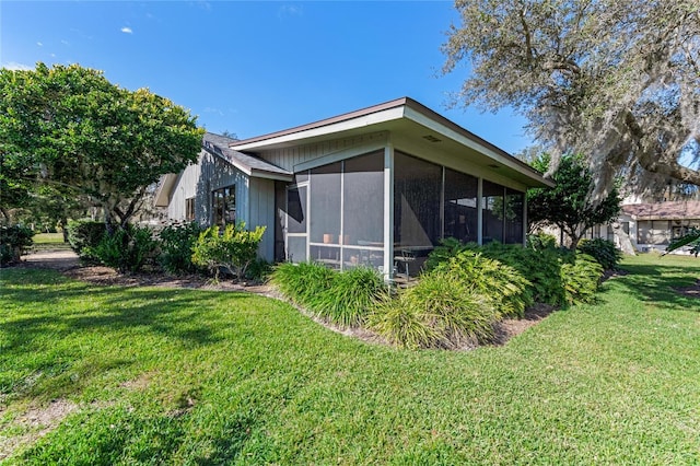 view of home's exterior featuring a yard and a sunroom