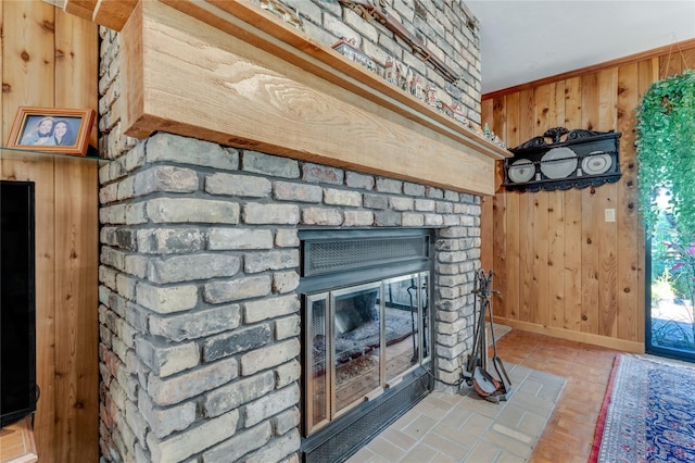 details with a brick fireplace and wooden walls