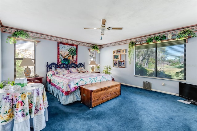 bedroom with ceiling fan and dark carpet