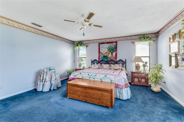 bedroom with multiple windows, ceiling fan, and carpet