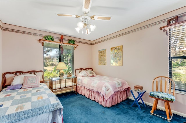 bedroom featuring multiple windows and dark colored carpet