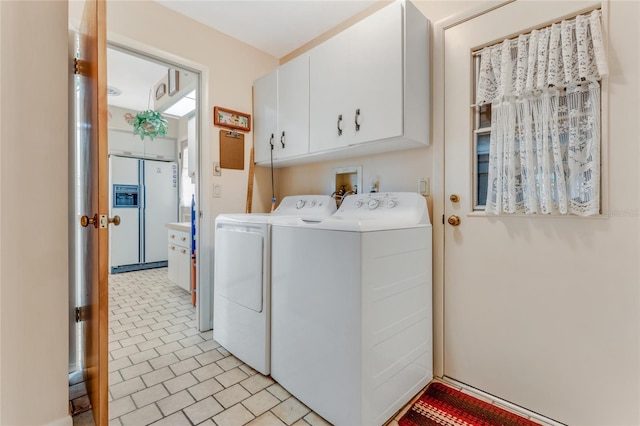 laundry room featuring cabinets and washing machine and clothes dryer